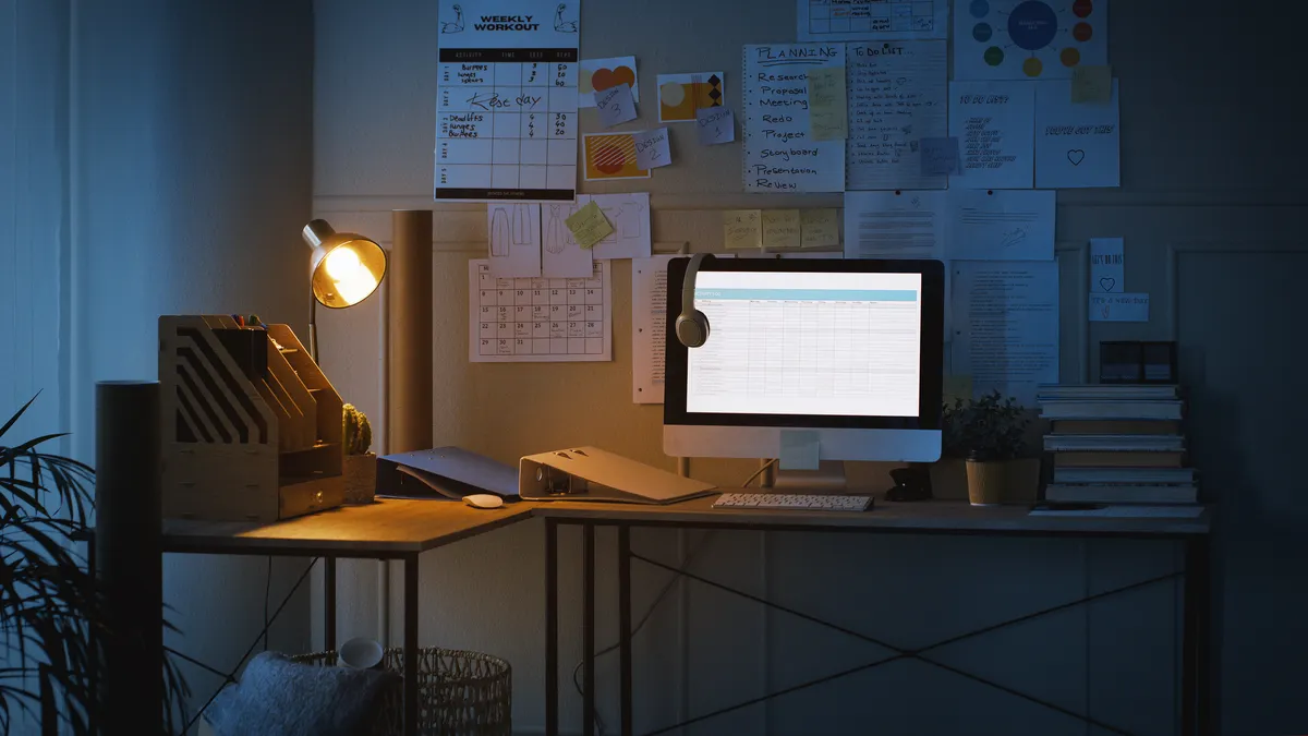 Shot of technology and paperwork on a desk in an empty home office at night