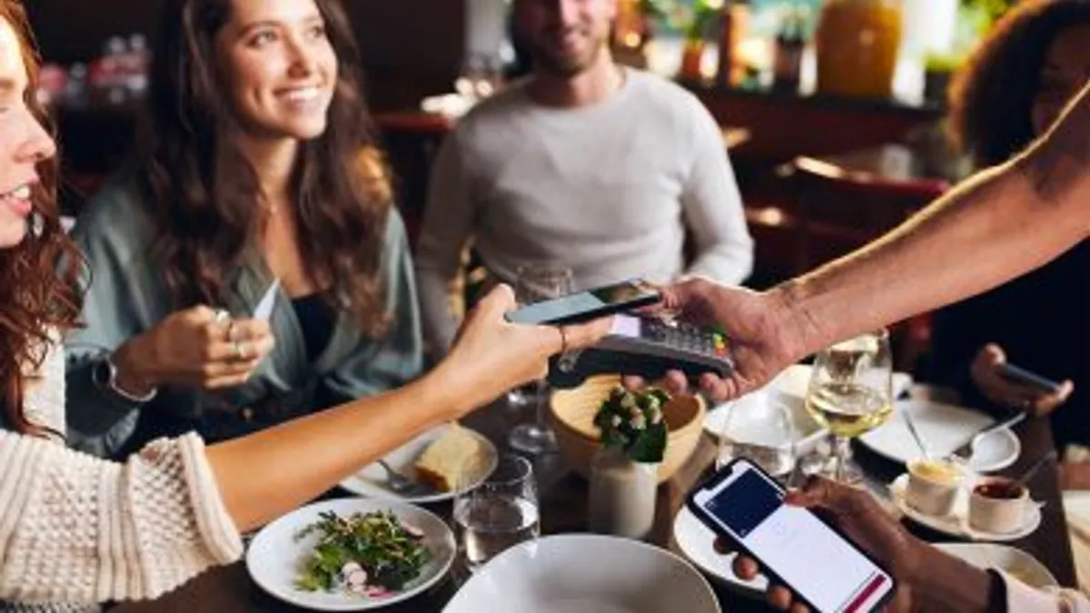 Contactless payment made a restaurant dinner table.