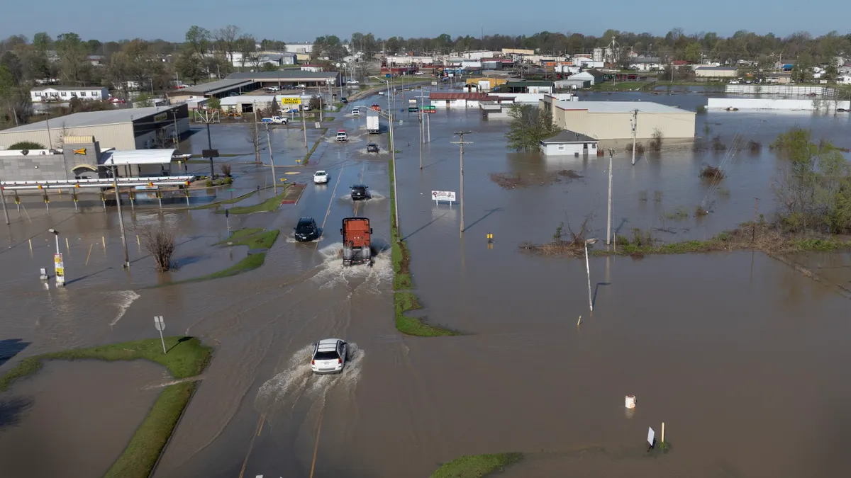 Aerial view of tornadoes driving through flooded street