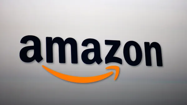 The Amazon logo is projected onto a screen,